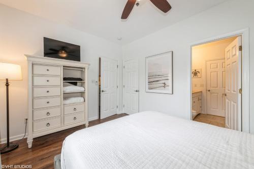 a white bedroom with a bed and a dresser at Comfy, Convenient Close to Rehoboth and Lewes! in Rehoboth Beach