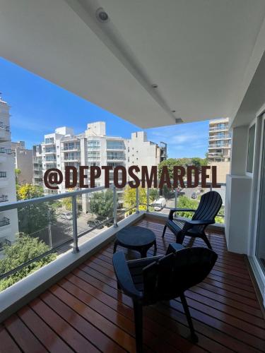 a balcony with two chairs and a view of a city at Roca Trust II Semipiso de 3 ambientes para 4 personas en zona güemes con cochera in Mar del Plata