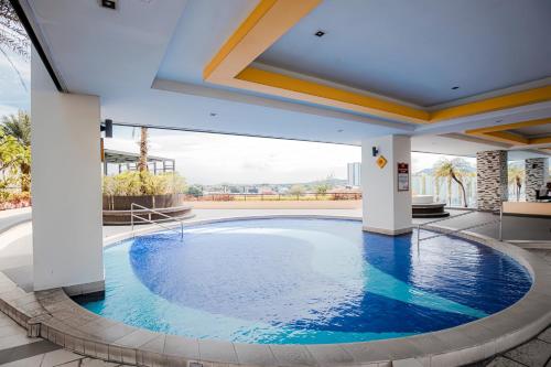 a large swimming pool in the middle of a building at The Majestic Ipoh in Ipoh