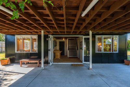 a porch of a house with a wooden ceiling at Close to the Lake in Taupo
