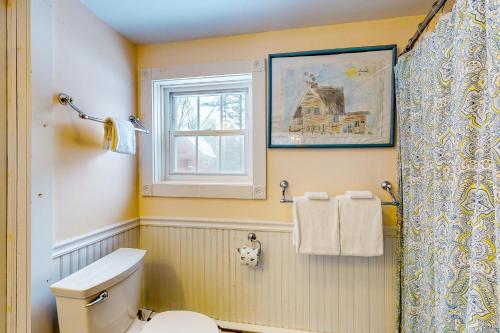a bathroom with a toilet and a window at The Stock Farm in Chestertown