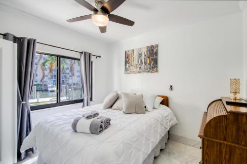 a bedroom with a bed and a ceiling fan at Marble House in Lauderdale Harbours in Fort Lauderdale