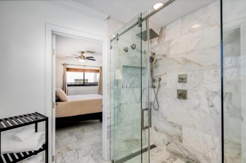 a bathroom with a shower with a glass door at Marble House in Lauderdale Harbours in Fort Lauderdale