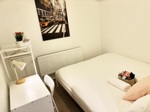a small room with two beds and a table at Benny's Rooms Brussels City Centre in Brussels