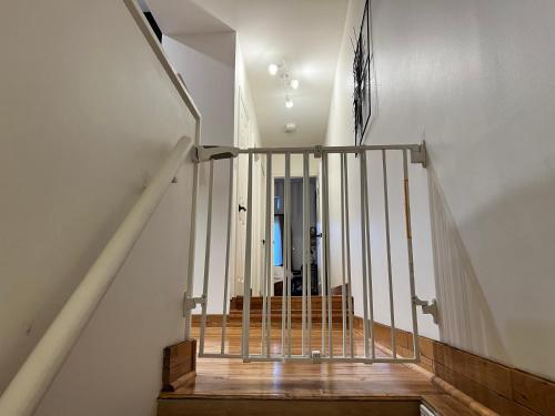 a staircase with a metal railing in a house at 3 Bedroom Victorian with Deck and Parking in Toronto