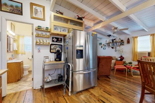 a kitchen with a stainless steel refrigerator in a room at The Collector's Hideaway in Burnet