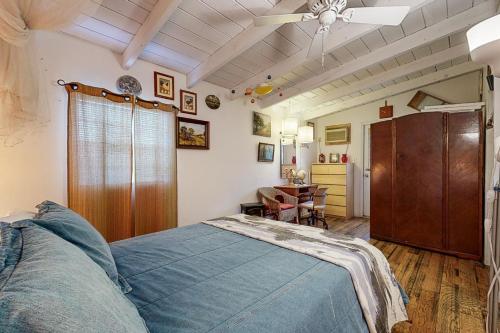 a bedroom with a bed and a ceiling fan at The Collector's Hideaway in Burnet