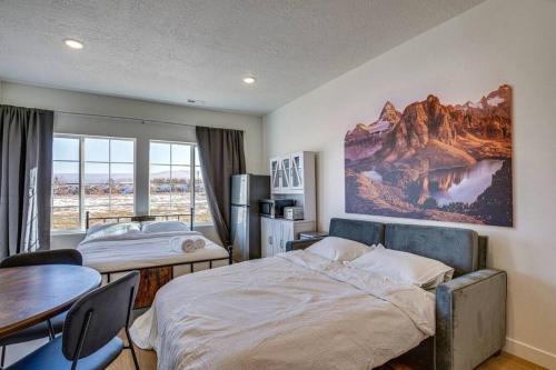 a bedroom with a bed and a table and a dining room at Mountain View Studio in Heber City