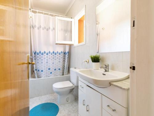 a bathroom with a sink and a toilet and a shower at Casa L'Escala, 4 dormitorios, 8 personas - ES-325-12 in Torroella de Montgrí