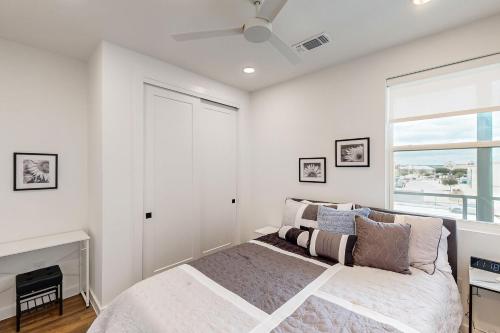 a white bedroom with a bed and a window at Mercer Retreat in New Braunfels