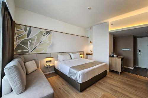 Tempat tidur dalam kamar di H Elite Design Hotel