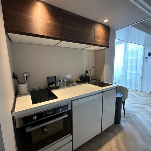 a kitchen with a sink and a stove at Hotel Grand Canal in Delft