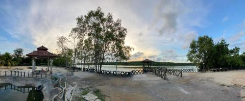 a park with a gazebo next to a lake at Beautiful River Homestay Kuala Pontian Rompin in Kuala Rompin