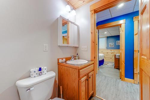 a bathroom with a toilet and a sink at Loafinit in Carrabassett