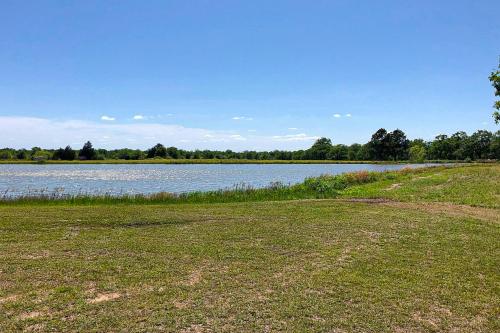 a large body of water with a grass field at Rudolph - Reindeer Ranch at Round Top in Carmine
