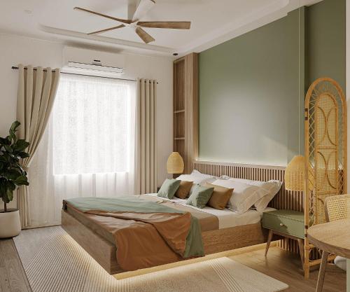 a bedroom with a large bed and a ceiling fan at The Urban Westlake Apartment in Hanoi