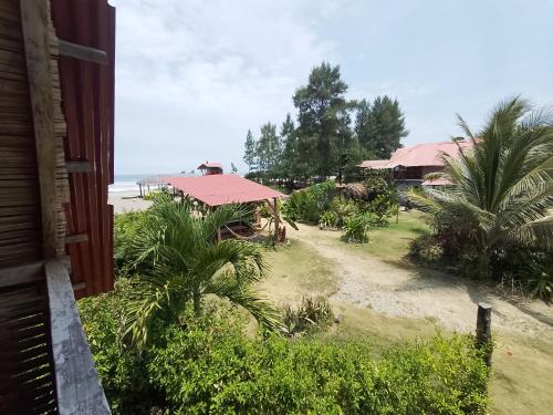 a view of the beach from a house at Hotel Palma Coco in Ayampe