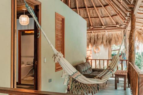 a hammock hanging from a room in a house at Hotel Isabella Tayrona in Los Naranjos