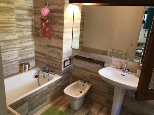 a bathroom with a sink and a tub and a toilet at Maison Bormes-les-Mimosas, 4 pièces, 6 personnes - FR-1-251-721 in Bormes-les-Mimosas