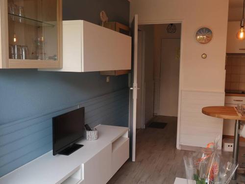uma cozinha com armários brancos e uma televisão no balcão em Appartement Bormes-les-Mimosas, 2 pièces, 4 personnes - FR-1-251-735 em Bormes-les-Mimosas