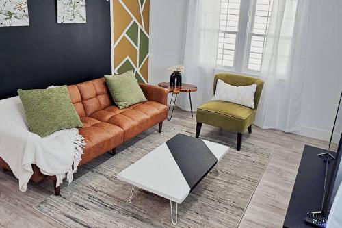 a living room with a couch and two chairs at Home Near Downtown Norfolk in Norfolk