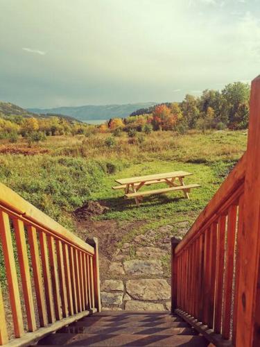 a wooden picnic table sitting on top of a field at Gîte de l'herboriste in Sainte-Rose-du-Nord