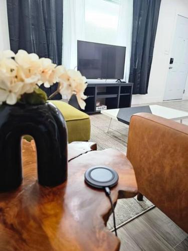 a living room with a vase of flowers on a table at Home Near Downtown Norfolk in Norfolk