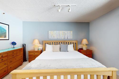 a bedroom with a bed and two dressers and two lamps at Lichenhearth # 4 in Snowmass Village