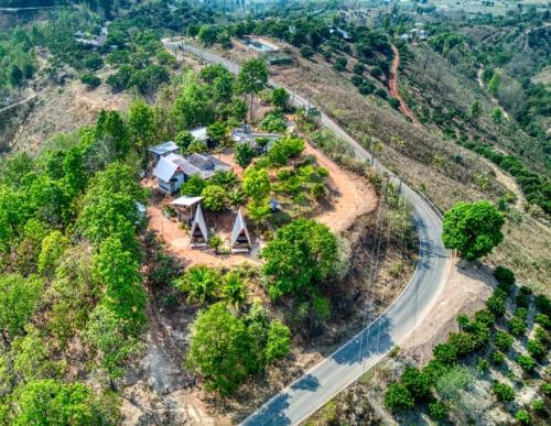 an aerial view of a house on a hill with a road at Monsonkeang Camping view ม่อนสันเกี๋ยง in Mae Chaem