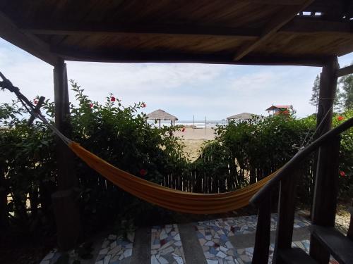 a hammock on the beach with a view at Hotel Palma Coco in Ayampe