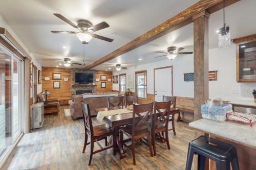 a dining room and living room with a table and chairs at Sparrow Cabin in Shaver Lake