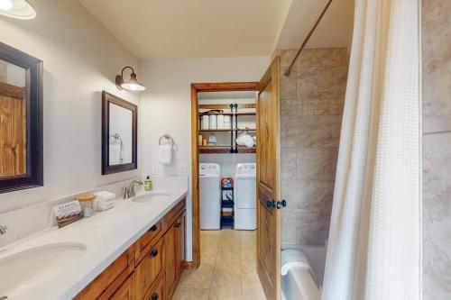 a bathroom with two sinks and a shower at Sparrow Cabin in Shaver Lake