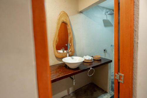 a bathroom with a sink and a mirror on a counter at Hotel Isabella Tayrona in Los Naranjos