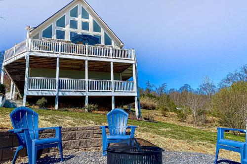 three blue chairs sitting in front of a house at Smoky Mountain Lake Retreat in Dandridge