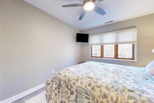 a bedroom with a bed and a ceiling fan at Oaks Paradise in Galena