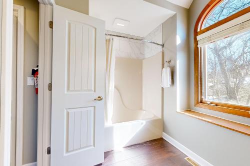 a bathroom with a bath tub and a window at Oaks Paradise in Galena