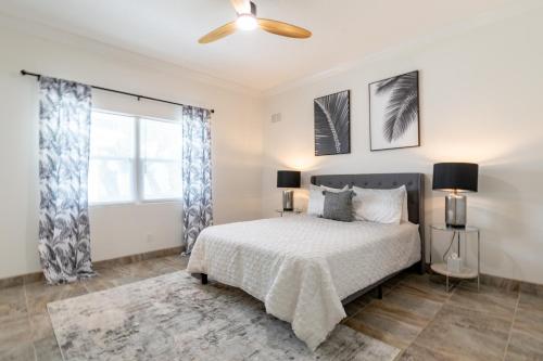 a bedroom with a bed and a ceiling fan at SōLE Luxury Condo's in Cocoa Beach