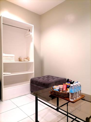 a living room with a coffee table and a couch at Airport Poddotel Inc. in Manila