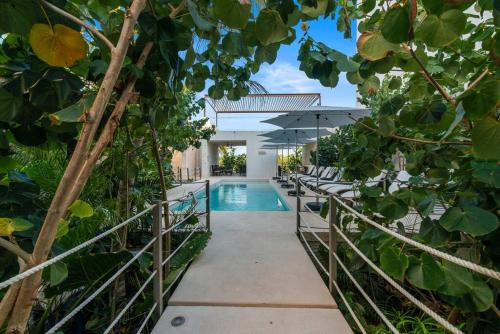 an external view of a house with a swimming pool at Akumal Skies Private Terrace W Jacuzzi W Sea Views Walk To Beach in Akumal