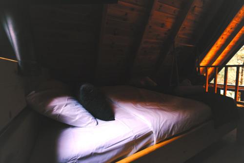 a bed in a room with two pillows on it at Golden Rose Bungalov in Ardeşen