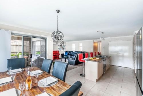 a kitchen and living room with a table and chairs at Oakdean Resort- Pool, Spa, Beach, Sleep 9 in Ocean Grove
