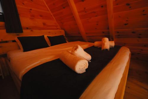 two stuffed animals laying on a bed in a room at Golden Rose Bungalov in Ardeşen