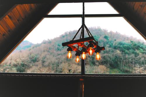 a chandelier hanging in front of a window at Golden Rose Bungalov in Ardeşen