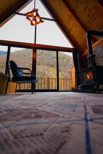 a view of a room with a fireplace and a chair at Golden Rose Bungalov in Ardeşen