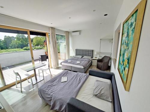盧比安納的住宿－Sunny terraces ROSE VALLEY, Ljubljana，一间卧室设有一张床和一间客厅。