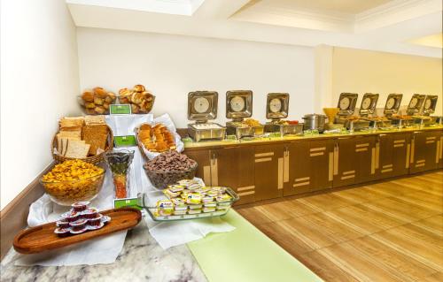 a buffet of food on a table in a room at Monarch Brigade Road in Bengaluru