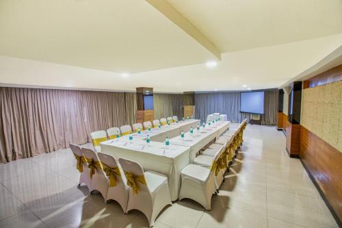 a large conference room with a long table and chairs at Monarch Brigade Road in Bengaluru