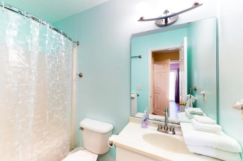 La salle de bains est pourvue d'un lavabo, de toilettes et d'un miroir. dans l'établissement Shelter in Peace, à North Topsail Beach