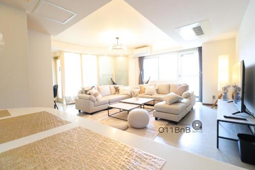 a living room with a couch and a table at NK BLD4F Sapporo 3LDK 3BR 1 floor 1 room in Sapporo