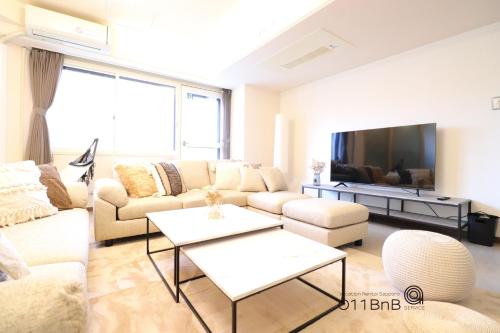 a living room with a couch and a tv at NK BLD4F Sapporo 3LDK 3BR 1 floor 1 room in Sapporo